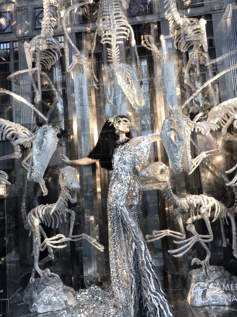 Bergdorf Goodman's 2017 holiday windows feature a To New York, With Love Theme showcasing several NYC institutions including the American Museum of Natural History with a window of crystal covered dinosaur skeletons.